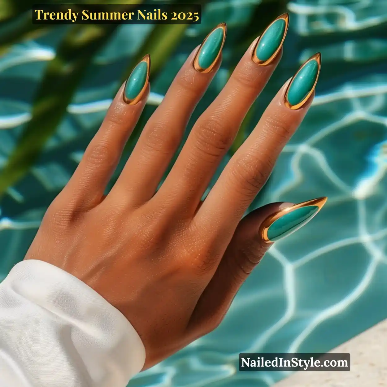 Trendy Summer Nails 2026: Top Designs, Colors & Ideas for the Season 27 Tan hand with long almond-shaped teal chrome nails outlined in gold, resting by a turquoise pool under sunlight.
