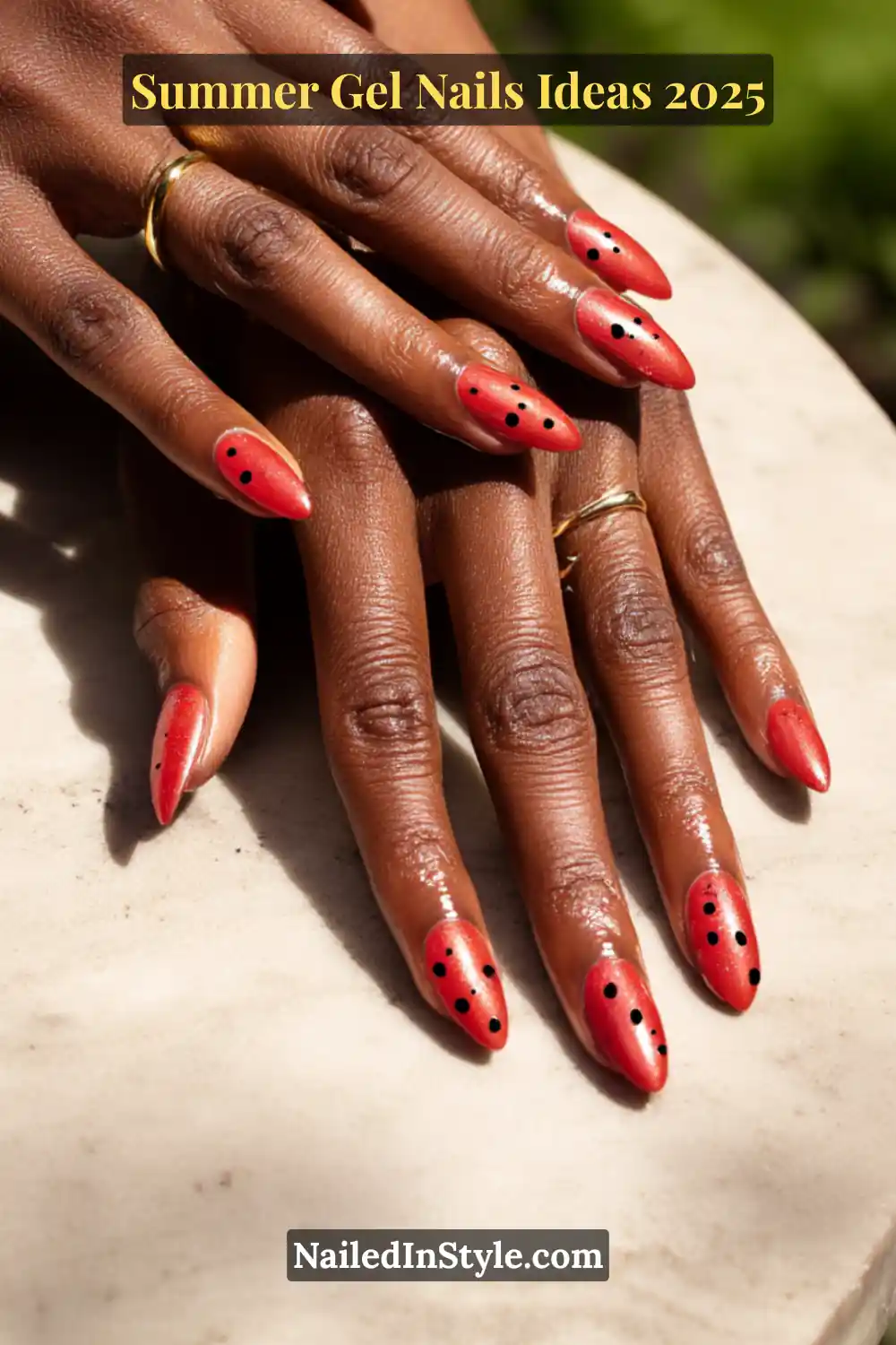 Summer Gel Nails Ideas 2026 11 Close-up of almond-shaped nails painted in shiny strawberry red chrome, detailed with scattered black dots to mimic seeds.