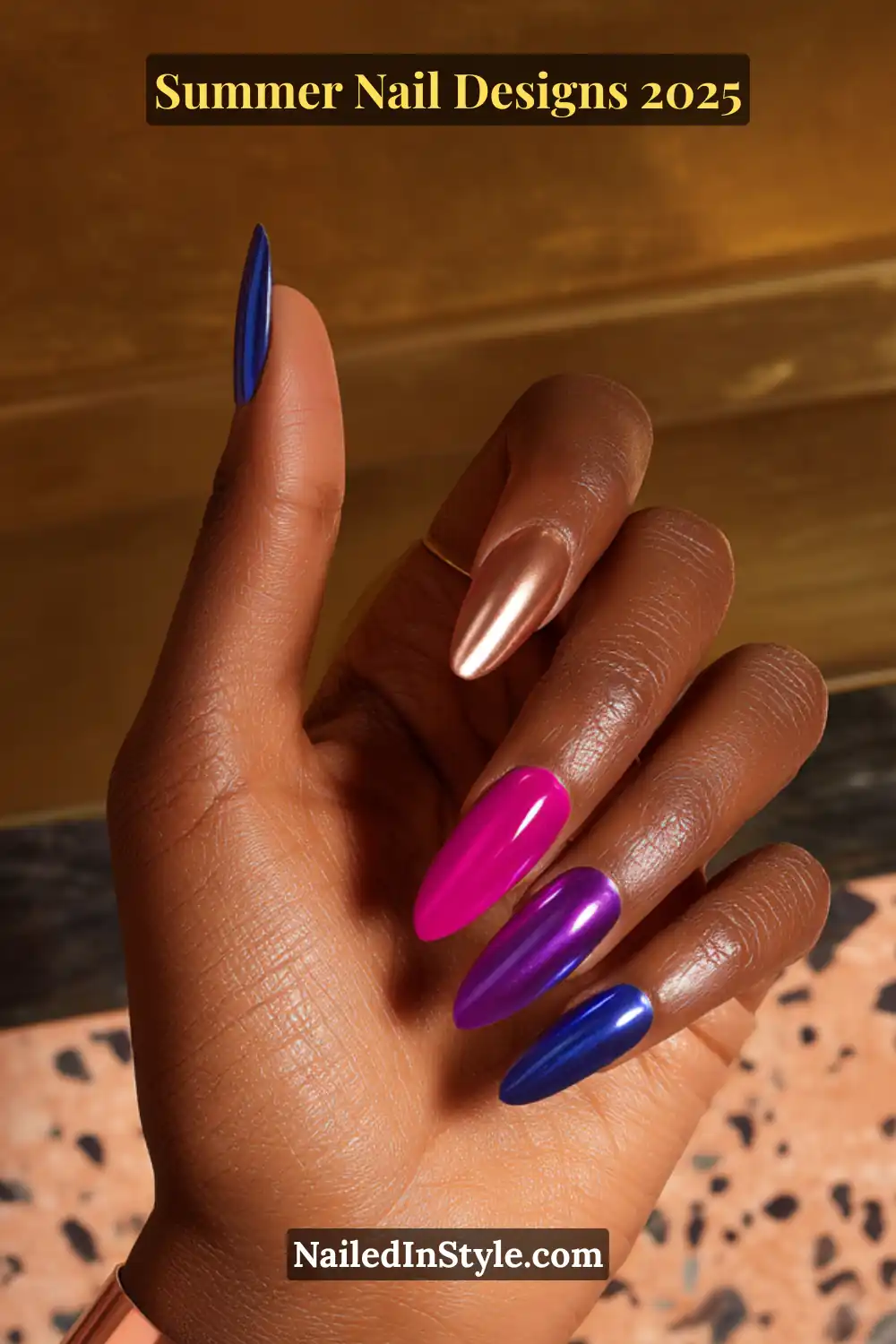 Deep skin tone hand with almond nails in fuchsia, chrome gold, and cobalt blue summer polish