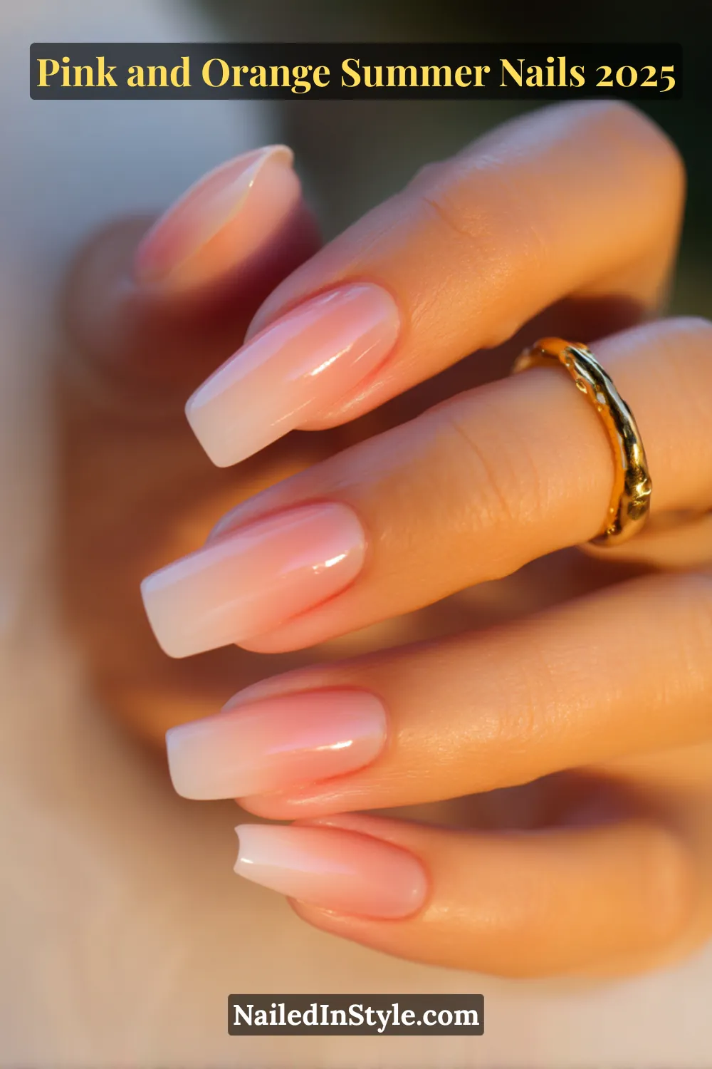 Pink and Orange Summer Nails 2026: Sunset Tips, Endless Vibes 20 Hand with long square-shaped nails featuring a glossy French fade in soft cloudy pink and pale orange, posed in soft light with a gold ring on fair skin.