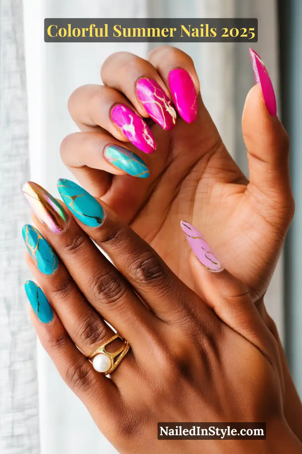 Colorful Summer Nails 2026: Bold, Fun & Bright Manicure Ideas 12 Two hands with deep brown skin tone featuring almond-shaped nails in fuchsia pink, turquoise blue, pastel lilac, and gold chrome with marble and metallic detailing