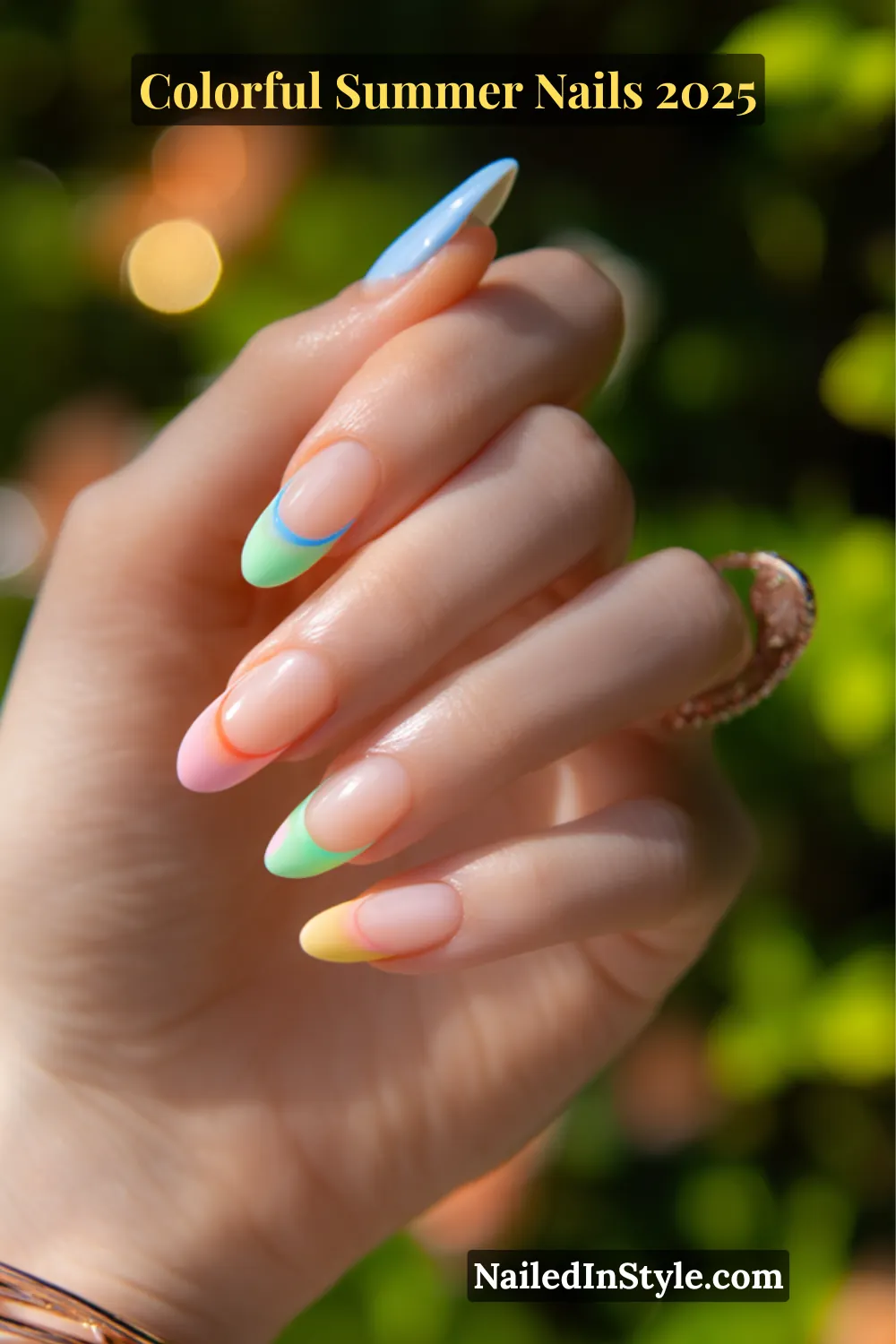 Colorful Summer Nails 2026: Bold, Fun & Bright Manicure Ideas 13 Hand with fair skin tone featuring almond-shaped nails with sheer nude base and colorful French tips in pastel yellow, mint green, baby blue, coral, and pink