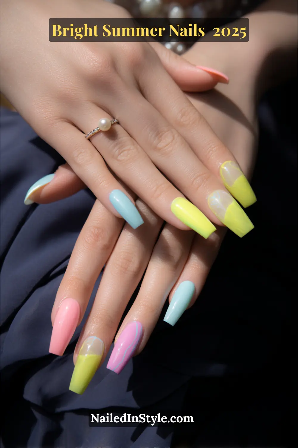 Fair-skinned hands with bright summer coffin nails in lemon yellow, hot pink, and baby blue, perfect for a warm and radiant seasonal manicure.