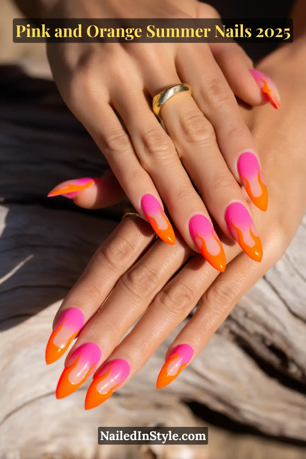 Pink and Orange Summer Nails 2026: Sunset Tips, Endless Vibes 25 Two hands with almond-shaped nails featuring neon pink bases and vibrant orange flame-shaped French tips.
