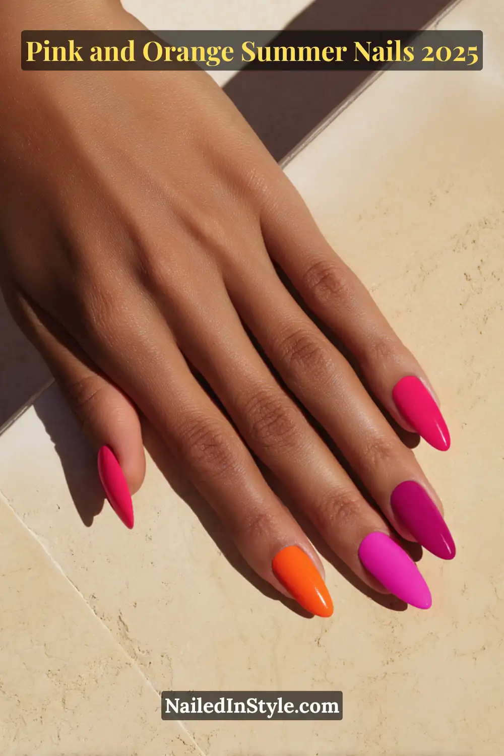 Pink and Orange Summer Nails 2026: Sunset Tips, Endless Vibes 4 Hand with almond-shaped glossy nails in vibrant pink, fuchsia, and orange shades, resting flat on a stone surface with olive-toned skin.