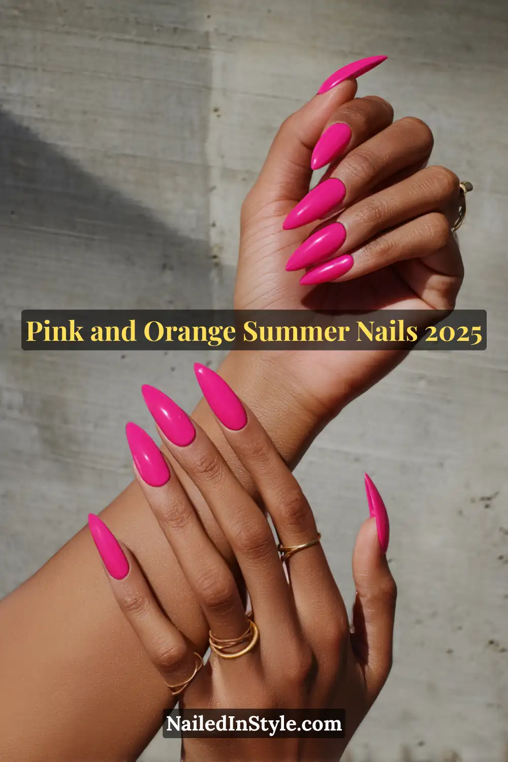 Pink and Orange Summer Nails 2026: Sunset Tips, Endless Vibes 21 Long almond-shaped nails painted in a hot pink glossy gel polish on deep skin, accessorized with gold rings against a concrete background.