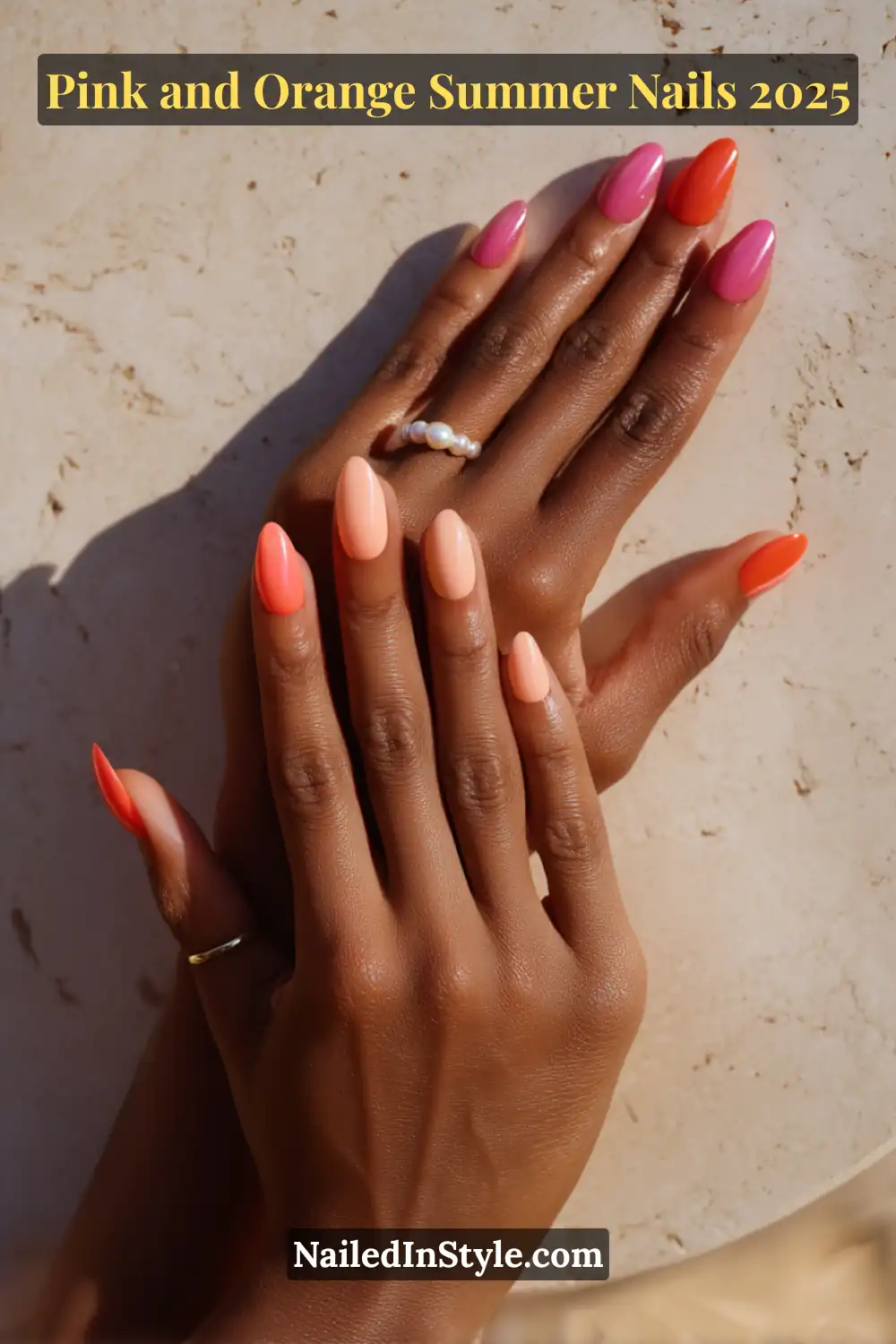 Pink and Orange Summer Nails 2026: Sunset Tips, Endless Vibes 3 Hands with almond-shaped glossy nails in pink and orange tones, posed relaxed on a sunlit stone surface, worn on medium skin with pearl and gold rings.