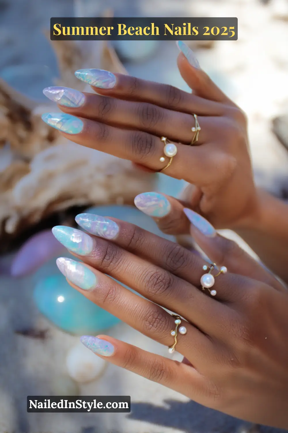 Summer Beach Nails 2026: Tropical, Trendy & Totally You 4 Close-up of a woman's hands with iridescent aqua and lavender nails featuring seashell patterns, pearl rings, and mermaid-inspired nail art