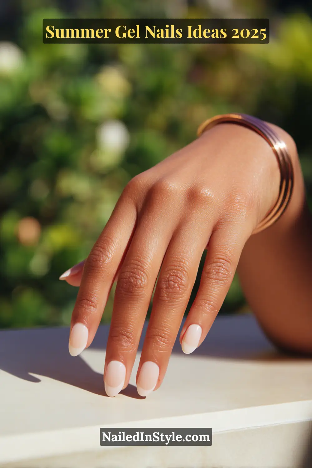 Summer Gel Nails Ideas 2026 19 Elegant hand with short almond-shaped nails featuring soft vanilla white French tips and blush pink undertones, perfect for summer.