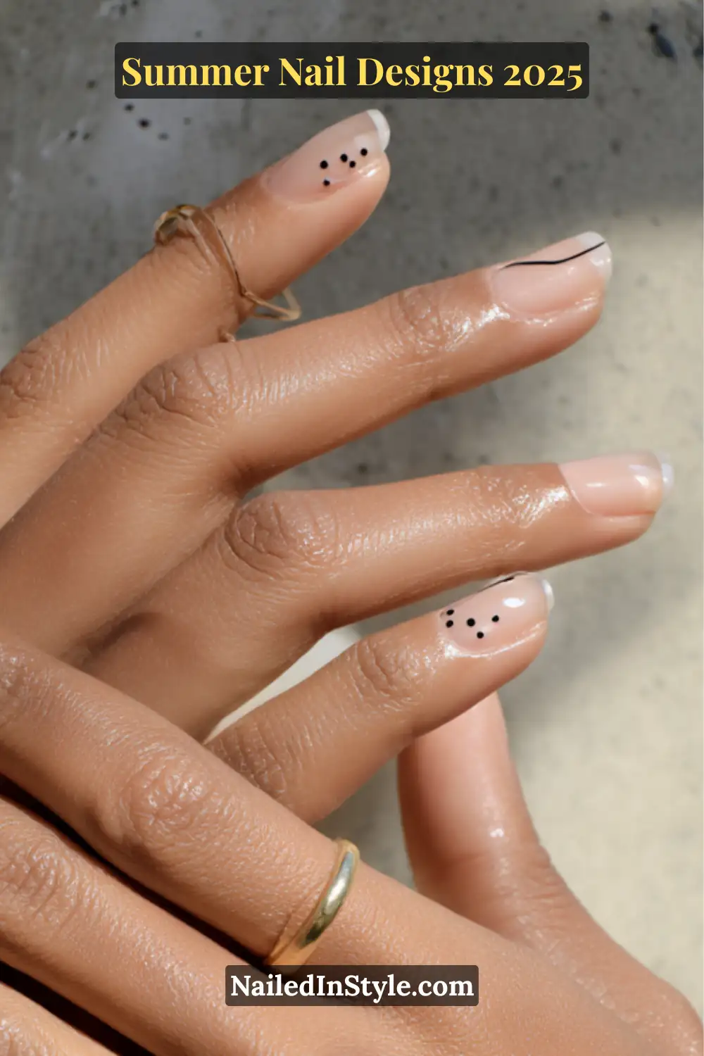 Minimal nail design featuring micro black dots and single-line art on a soft neutral-toned base
