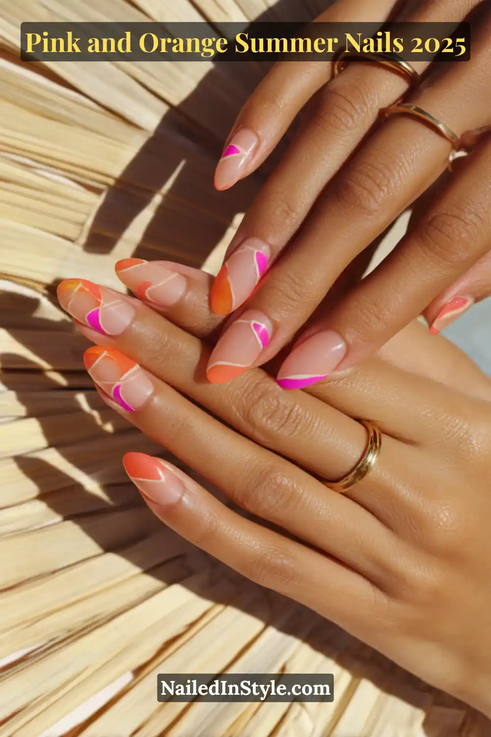 Pink and Orange Summer Nails 2026: Sunset Tips, Endless Vibes 15 Hands with almond-shaped nails featuring pink and orange abstract swirl accents over a clear base, with negative space and white outlines, posed on warm-toned skin and straw background.