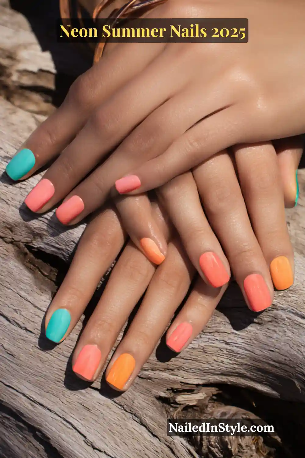 Neon Summer Nails 2026: Bright, Bold & Sun-Soaked Perfection 3 Medium-toned hands with short square nails painted in vibrant coral, neon tangerine, and turquoise polish, resting on driftwood.