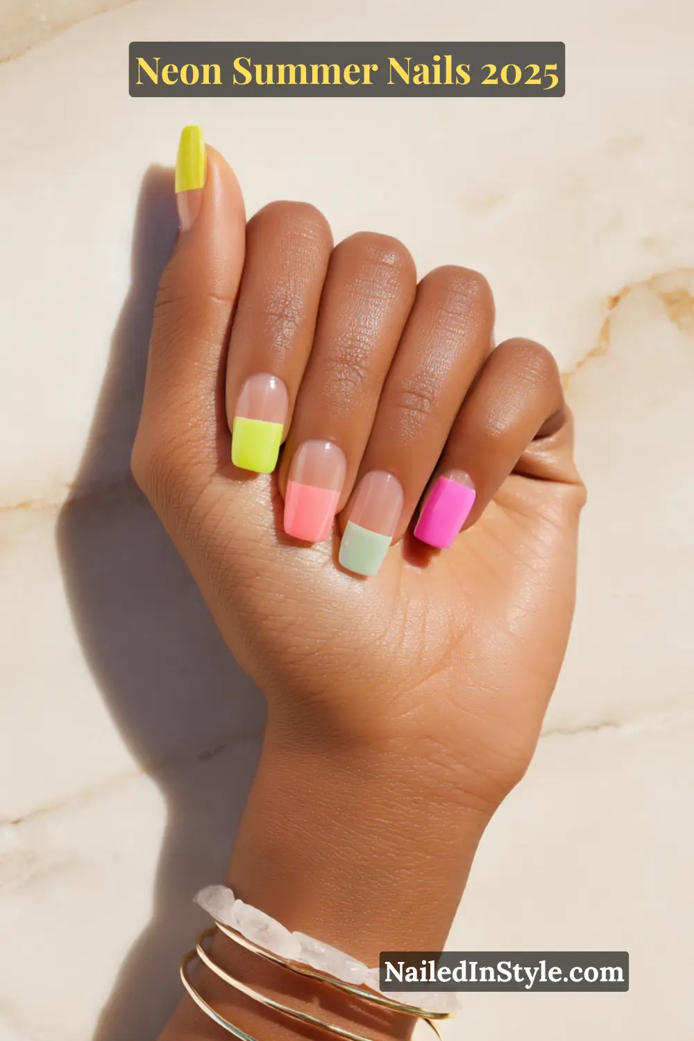 Neon Summer Nails 2026: Bright, Bold & Sun-Soaked Perfection 25 Hand with clear square-shaped nails featuring bold neon block tips in yellow, pink, mint, and orange hues.