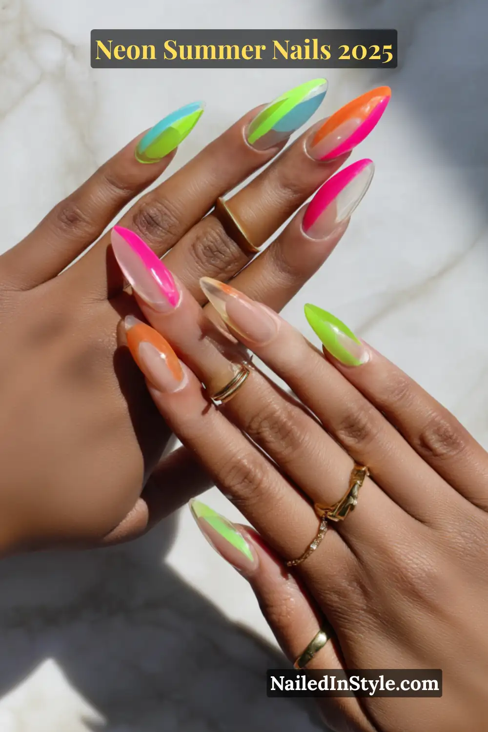 Neon Summer Nails 2026: Bright, Bold & Sun-Soaked Perfection 9 Two hands with long, almond-shaped clear jelly nails featuring bold neon stripe accents in pink, lime, orange, and blue.