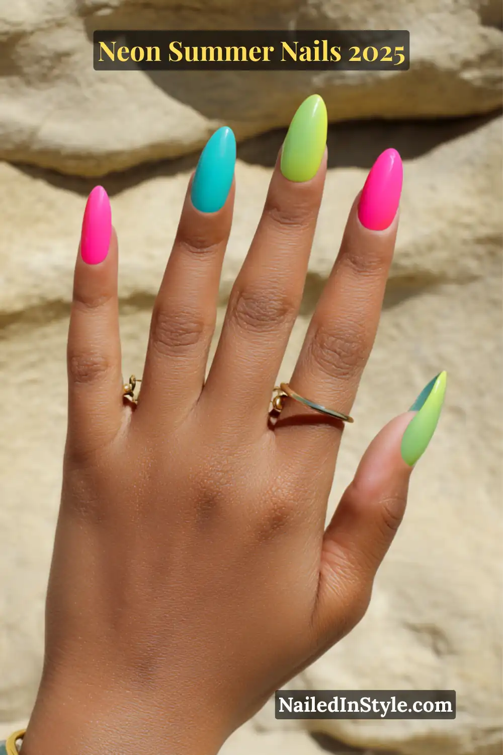 Neon Summer Nails 2026: Bright, Bold & Sun-Soaked Perfection 4 Close-up of an olive-toned hand with almond-shaped nails painted in neon lime green, teal, and hot pink shades, styled with simple gold rings.