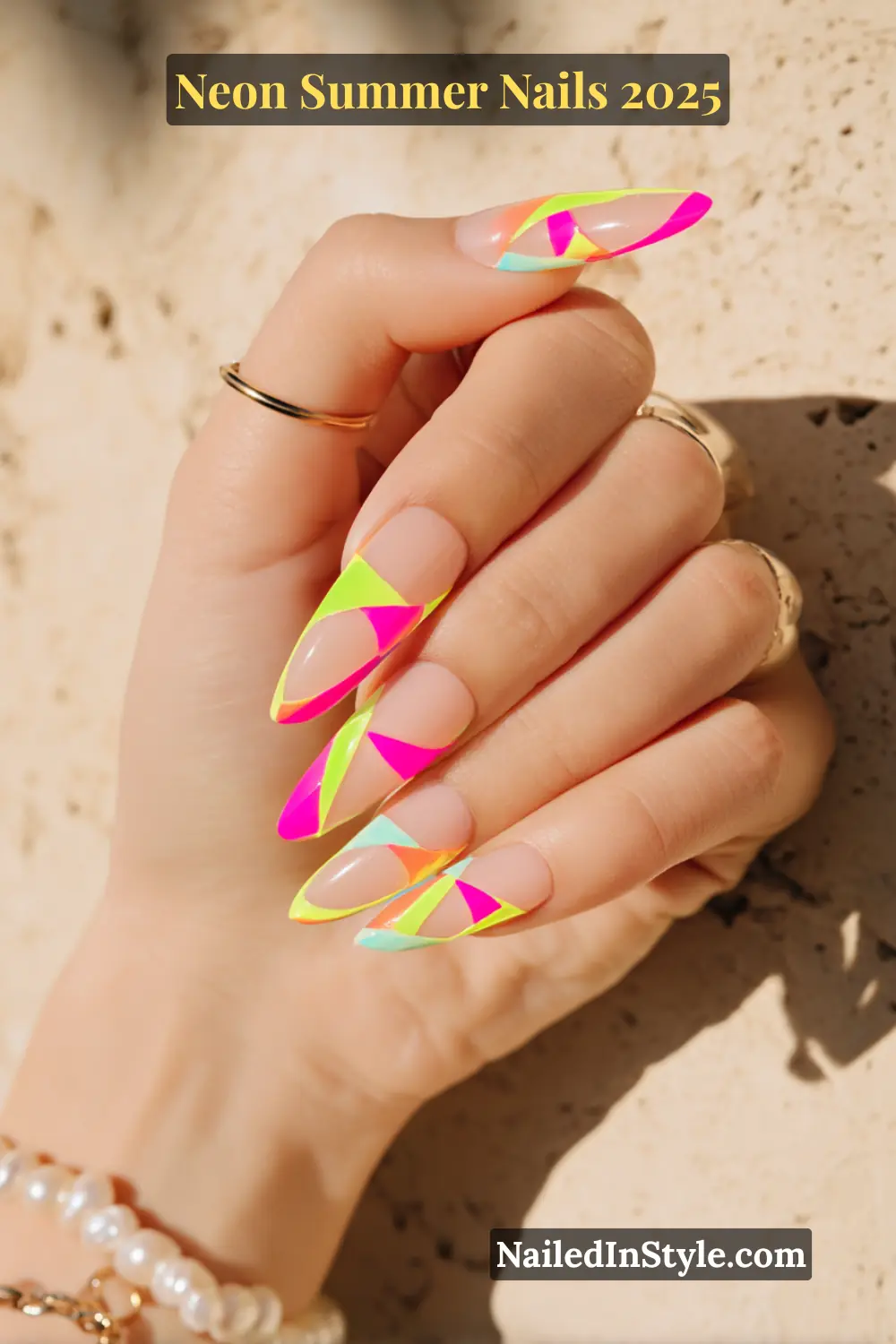 Neon Summer Nails 2026: Bright, Bold & Sun-Soaked Perfection 19 Hand with almond-shaped nails featuring neon geometric cutouts and negative space design.