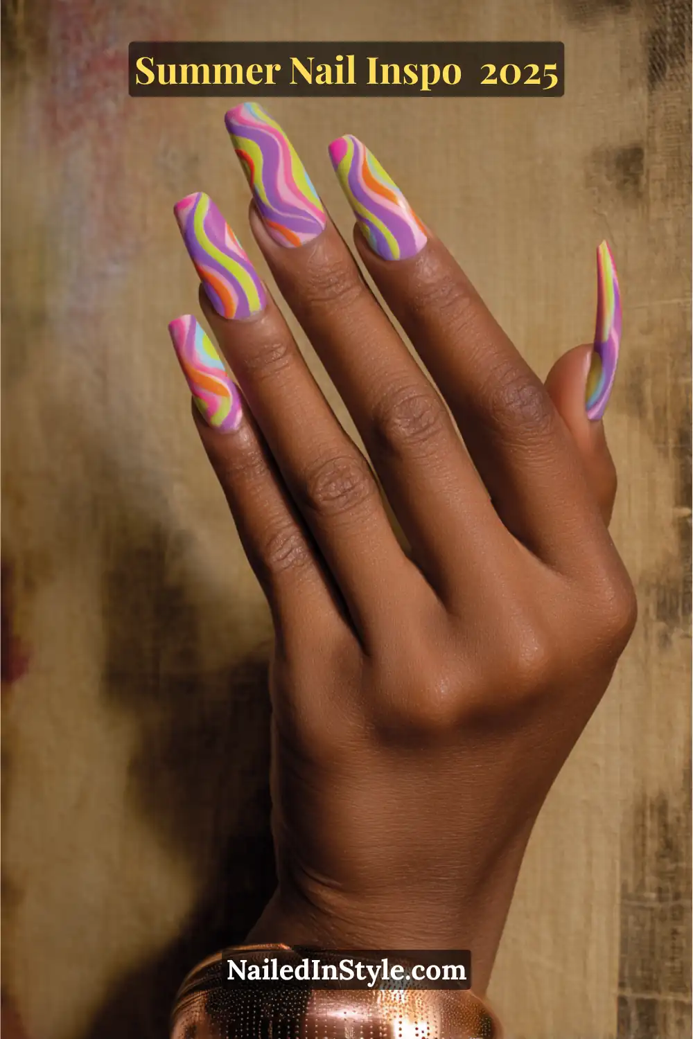 Close-up of a hand with long square nails featuring multicolored neon swirl nail art in pink, orange, lime, lavender, and yellow shades.