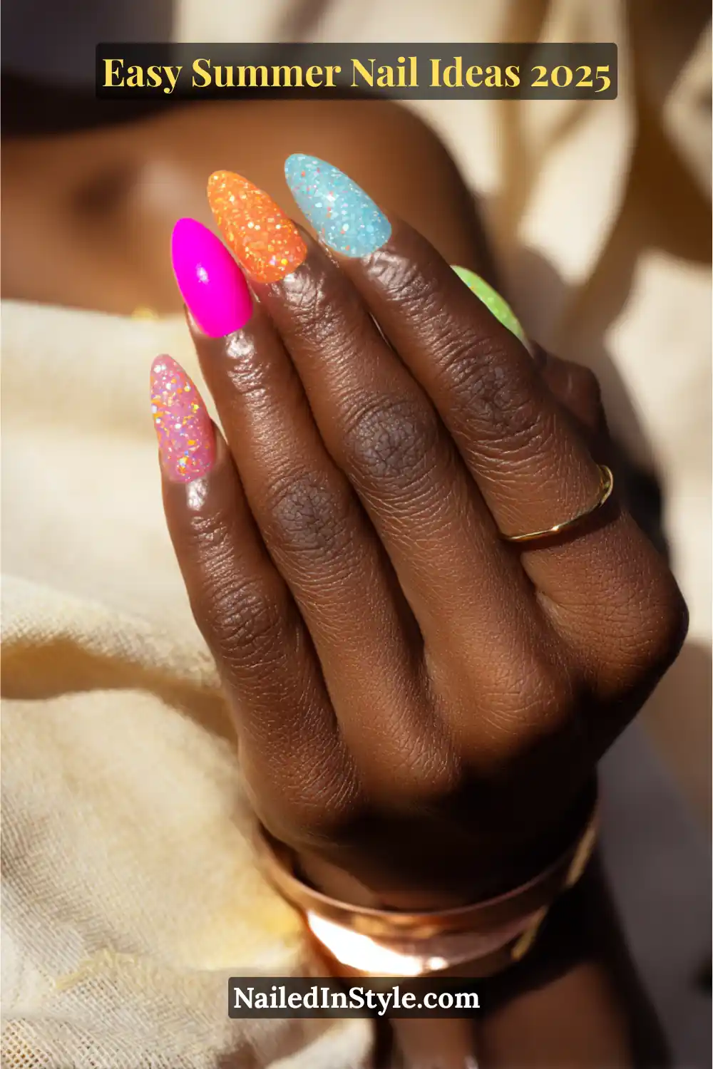 Easy Summer Nail Ideas 2026 That Look Gorgeous with Minimal Effort 8 Hand with almond-shaped summer gel nails featuring bold neon and pastel shades—pink, orange, blue, green—with a sparkling glitter topcoat, 2025 party nail trend.