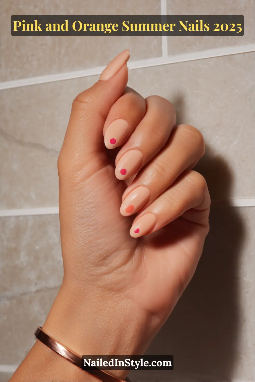 Pink and Orange Summer Nails 2026: Sunset Tips, Endless Vibes 18 Hand with almond-shaped nails in a peach BIAB (builder in a bottle) base featuring glossy pink and orange dot accents, posed against a tiled neutral background.