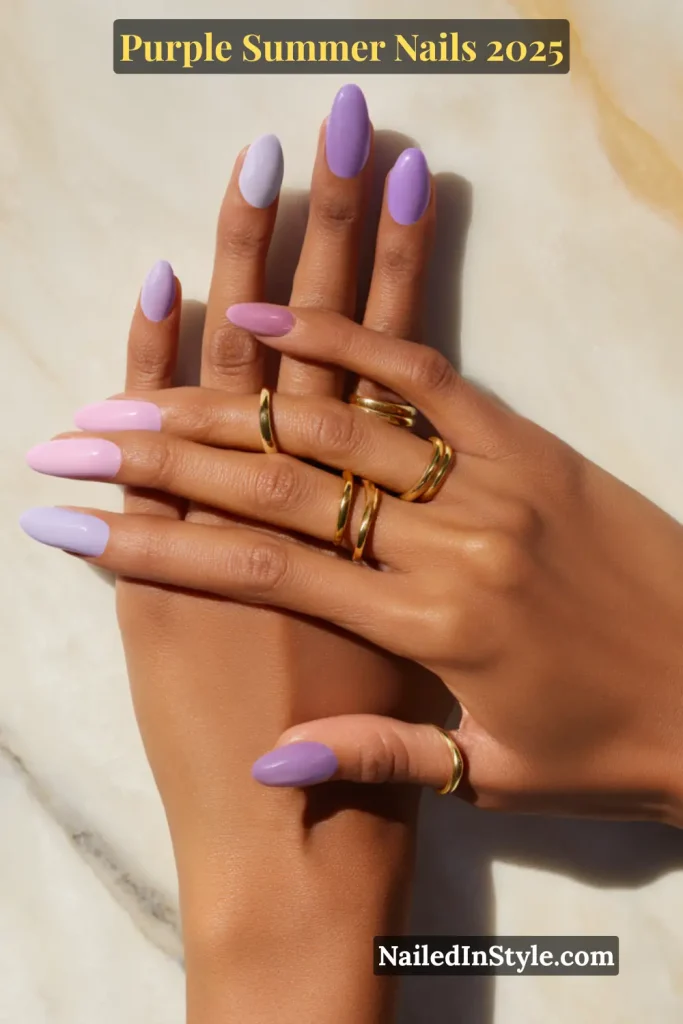Purple Summer Nails Two hands with oval nails painted in pastel and lavender purple shades, arranged in a gentle overlapping pose.