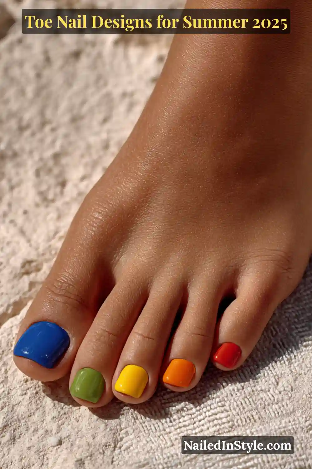 Toe Nail Designs for Summer 2026: Fresh Looks for Every Step 27 Close-up of a dark-toned female foot with each toenail painted in a different bright color, resting on textured stone