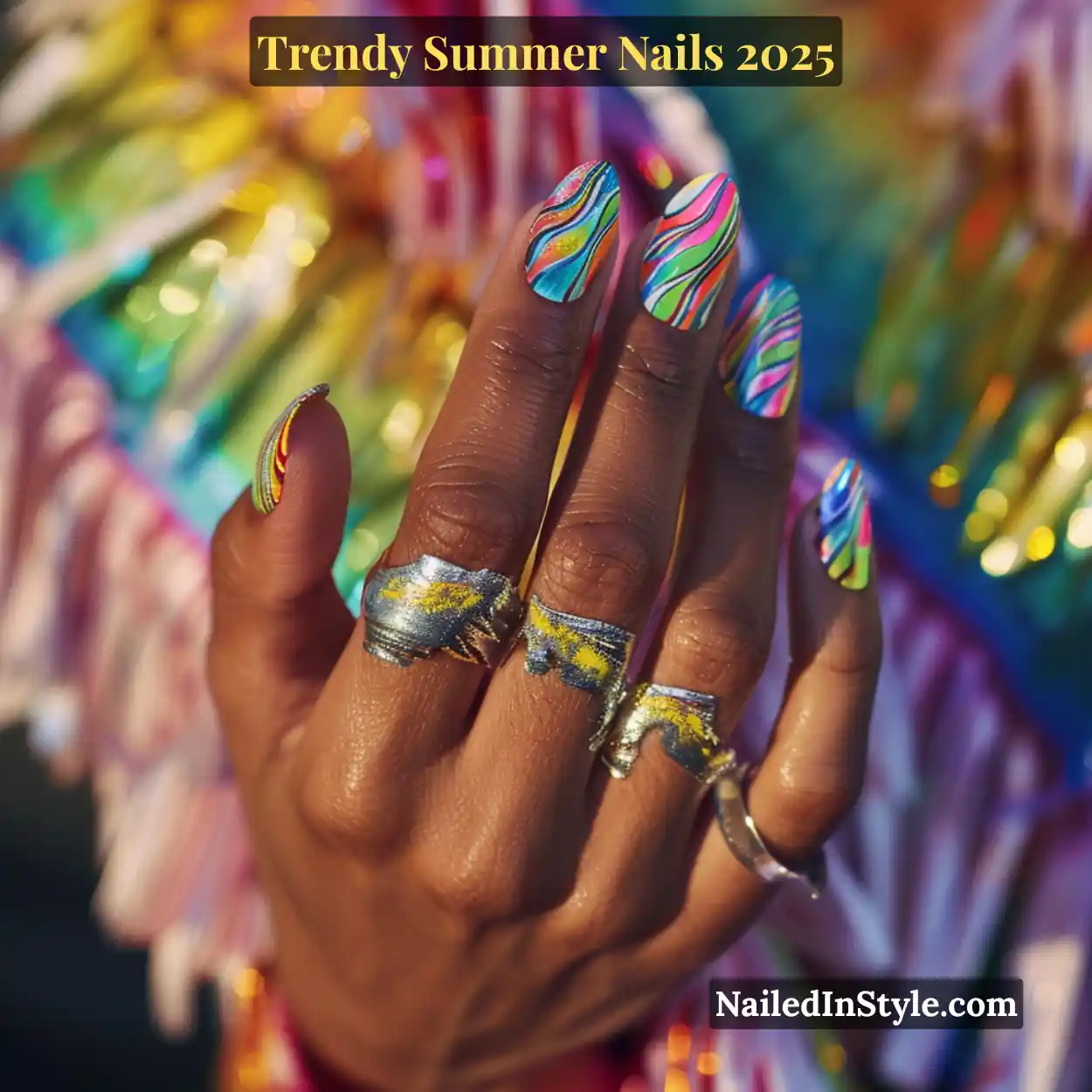 Trendy Summer Nails 2026: Top Designs, Colors & Ideas for the Season 33 Deep-toned hand with almond-shaped rainbow marble nails featuring bright swirling stripes in neon pink, yellow, green, blue, and orange, styled with chunky silver rings at a summer festival.
