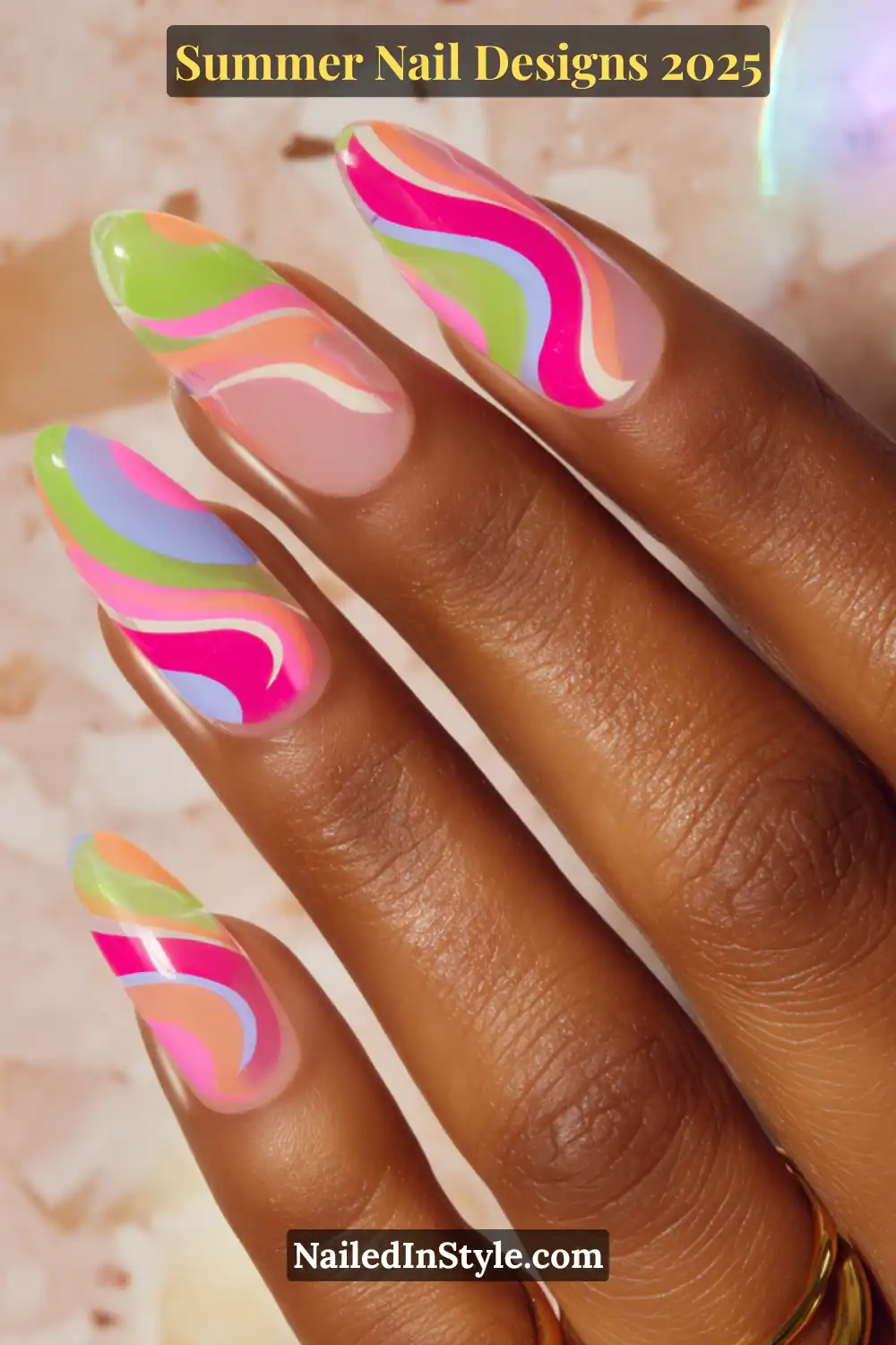 Hand with long almond nails featuring neon rainbow swirl nail art in pink, green, blue, and peach on a translucent base