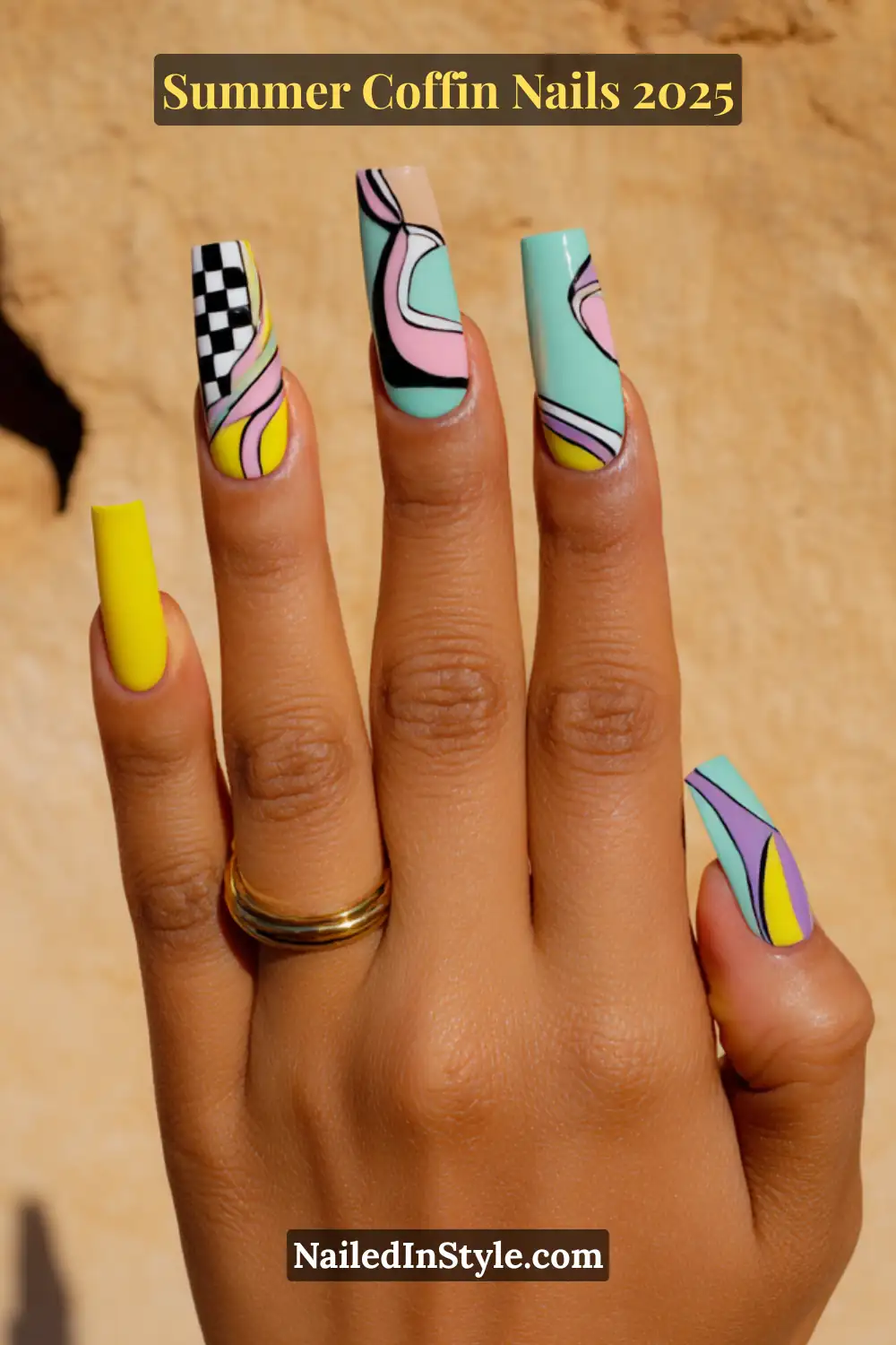 Close-up of a hand with long coffin nails featuring pastel swirl art, checkerboard pattern, and lemon yellow accents against a warm beige background