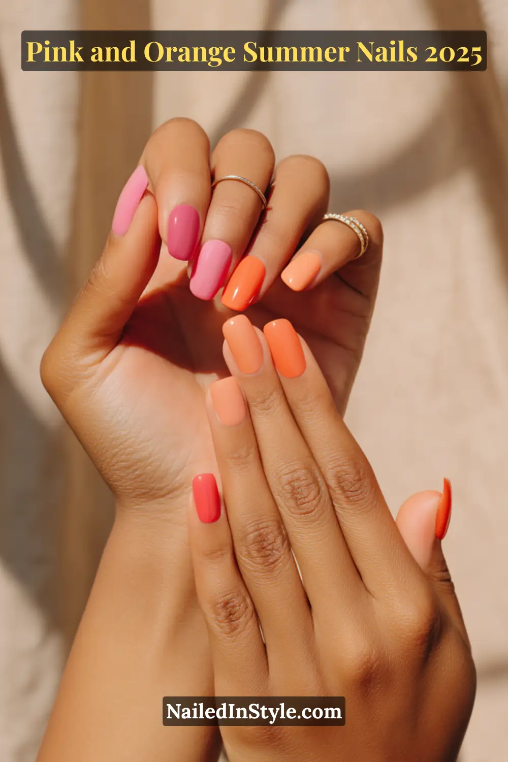 Pink and Orange Summer Nails 2026: Sunset Tips, Endless Vibes 2 Hand with square-shaped glossy nails in alternating shades of pink and orange, side angle pose on fair skin with subtle background shadows.