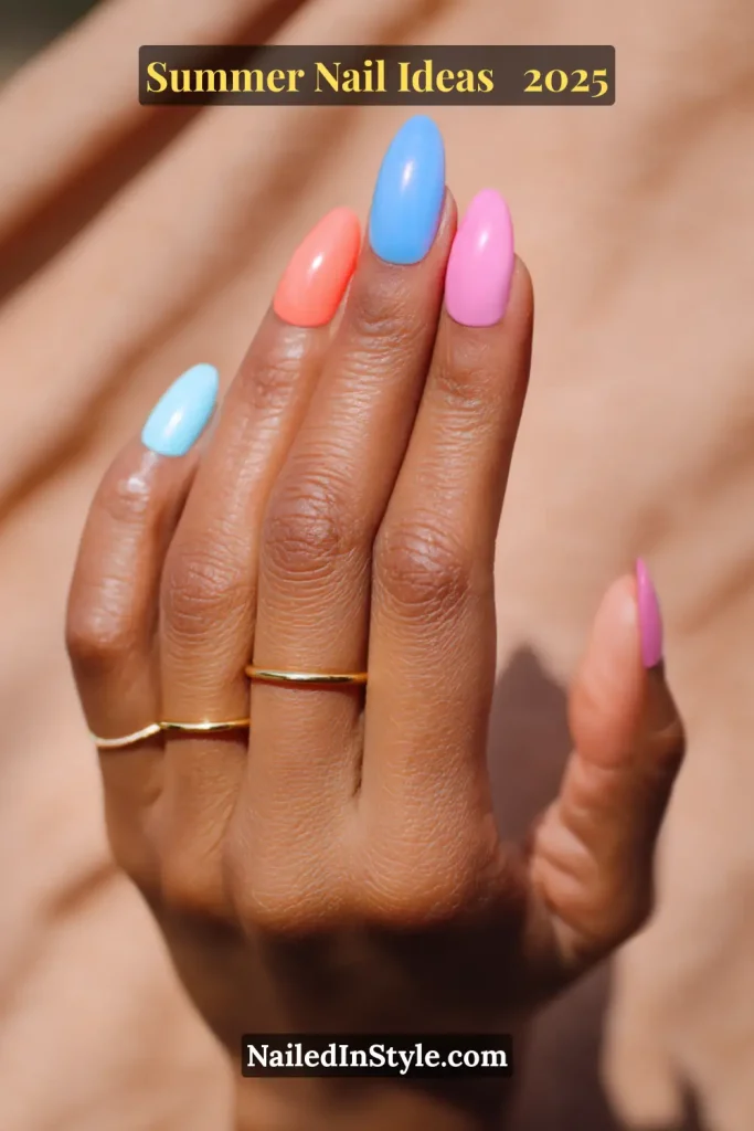 Almond-shaped nails painted in bright pastel hues: sky blue, coral, cobalt blue, bubblegum pink, and soft peach.