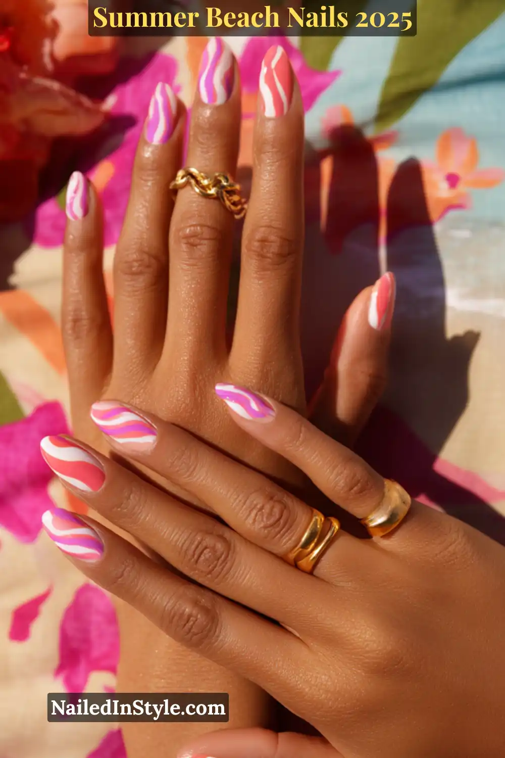 Summer Beach Nails 2026: Tropical, Trendy & Totally You 14 Close-up of two hands with coral, fuchsia, and white swirl nails on medium skin tone, against tropical background
