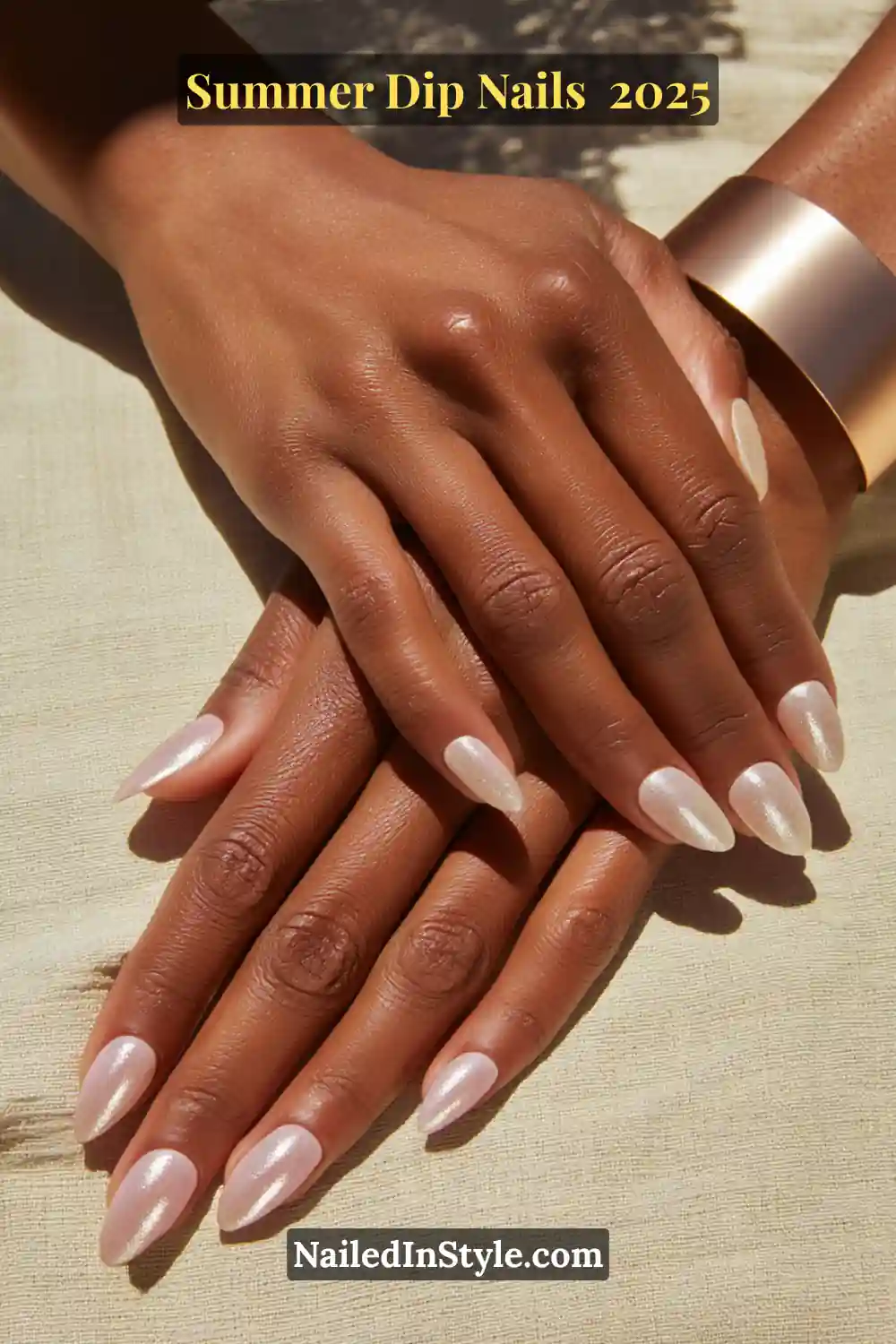Elegant almond-shaped nails with a soft sheer base topped with a pearlescent chrome finish, styled on deep skin.