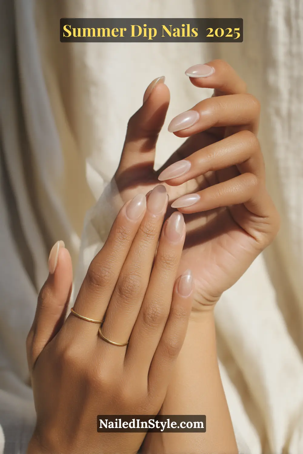 Almond-shaped dip nails in sheer pink and beige with a glazed chrome finish, held elegantly with gold rings.