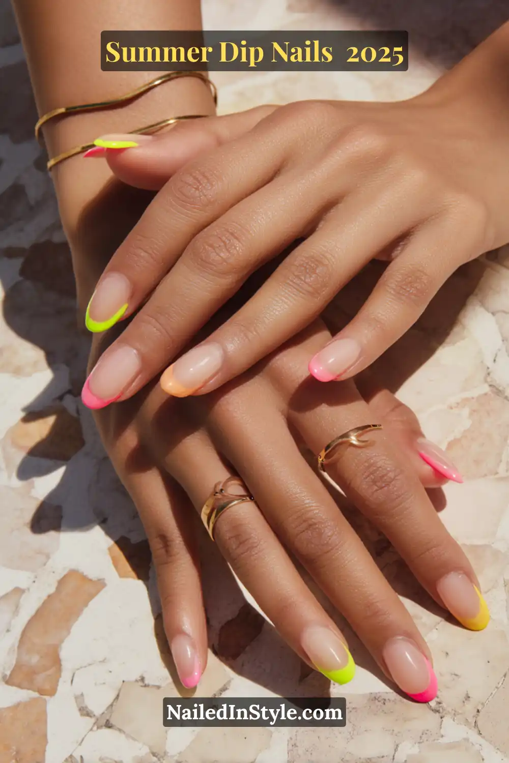 Close-up of hands with almond-shaped nude dip nails featuring vibrant neon French tips in pink, yellow, green, and orange.