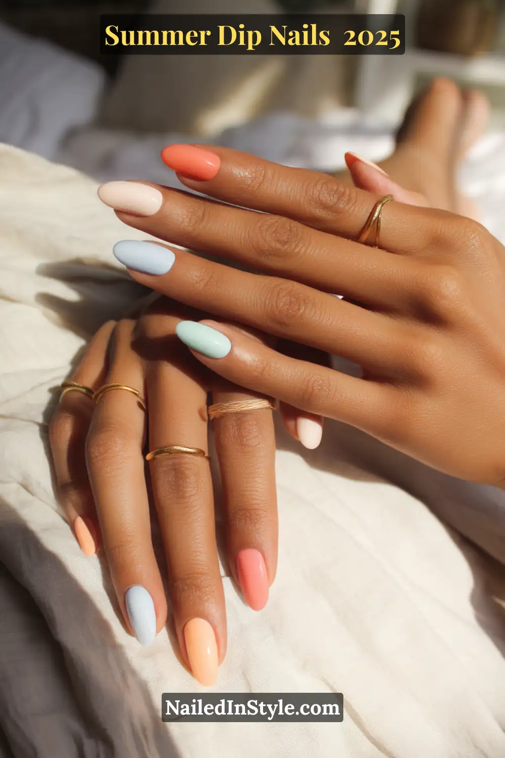 Two hands with almond-shaped dip nails in coral, mint green, peach, and soft blue shades—perfect for light skin tones.
