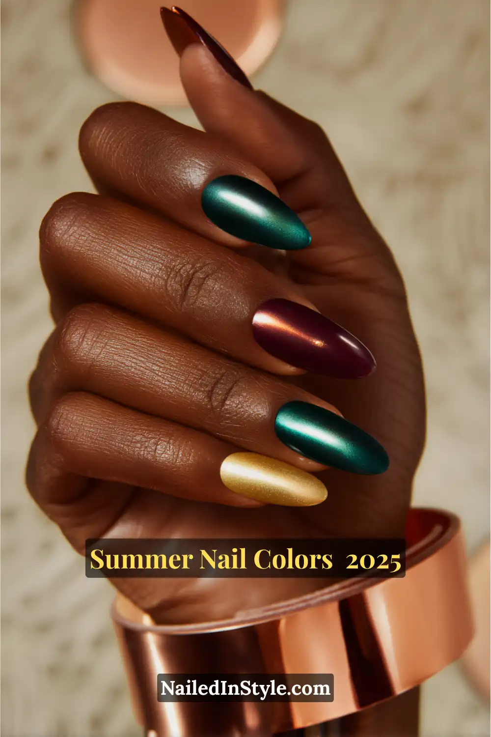 Hottest Summer Nail Colors 2026: Bold, Breezy & On-Trend 11 A deep-toned hand with metallic gold, berry red, and electric green nails, accented by a rose-gold cuff bracelet.