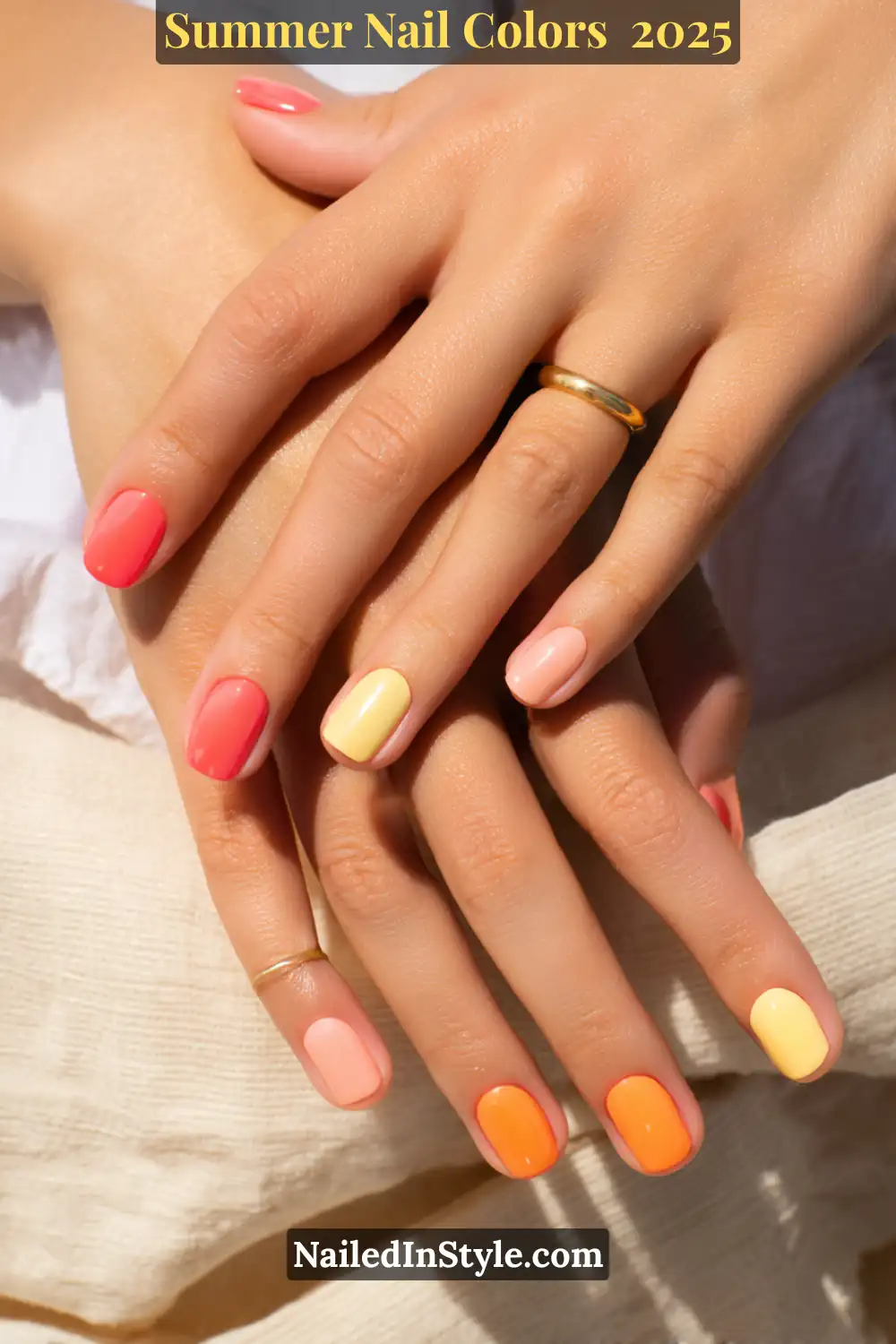 Hottest Summer Nail Colors 2026: Bold, Breezy & On-Trend 8 Close-up of hands with coral, peach, and butter yellow nail polish, ideal for light skin with golden undertones.