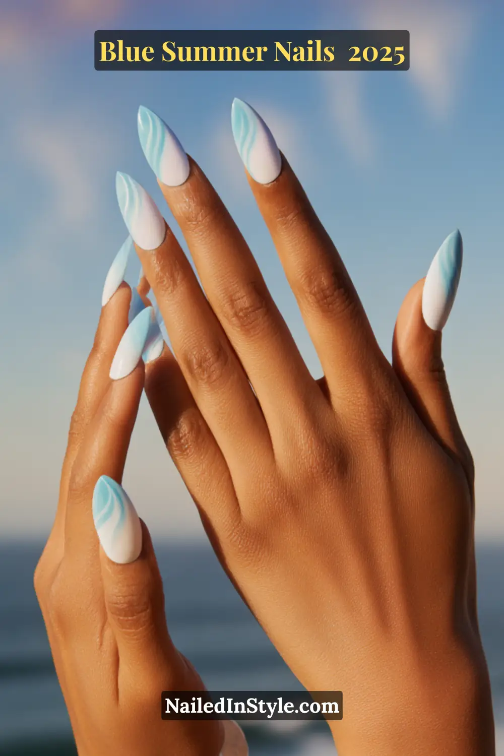 Blue Summer Nails 2025: Make a Splash with the Coolest Trends of the Season 13 Close-up of hands with long almond-shaped nails featuring blue ombré wave art fading into white tips.
