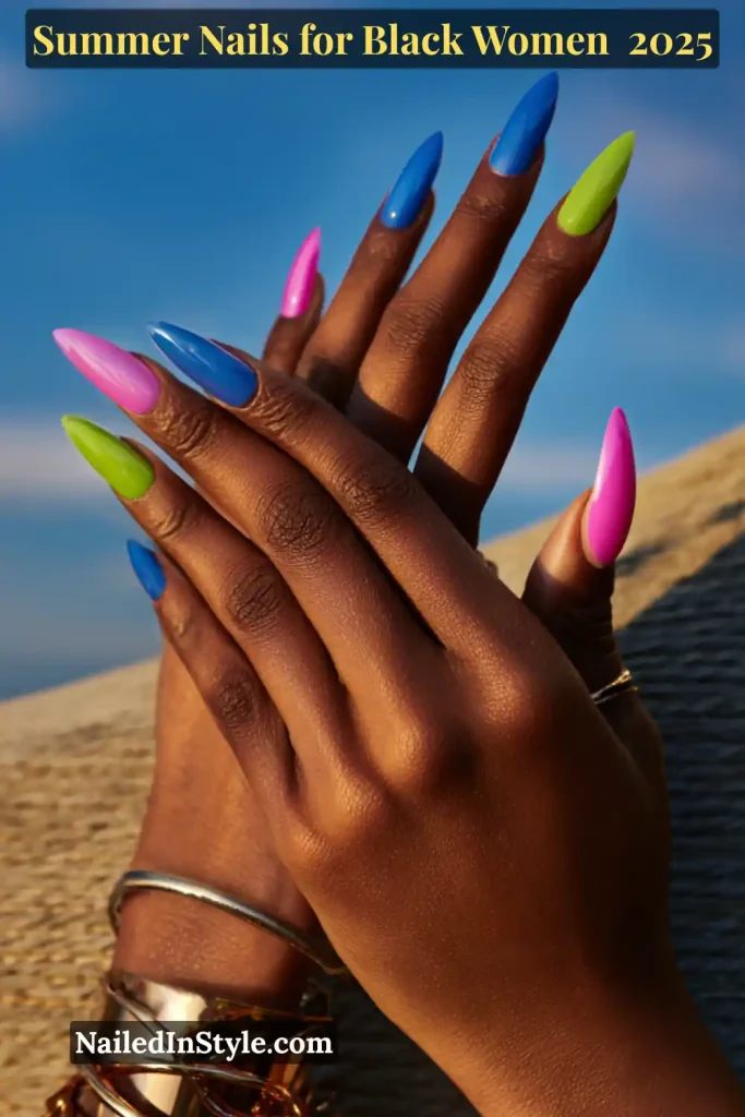 Summer Nails for Black Women Close-up of a Black woman's hands with bold summer nails in pink, blue, and neon green, featuring long almond shapes.