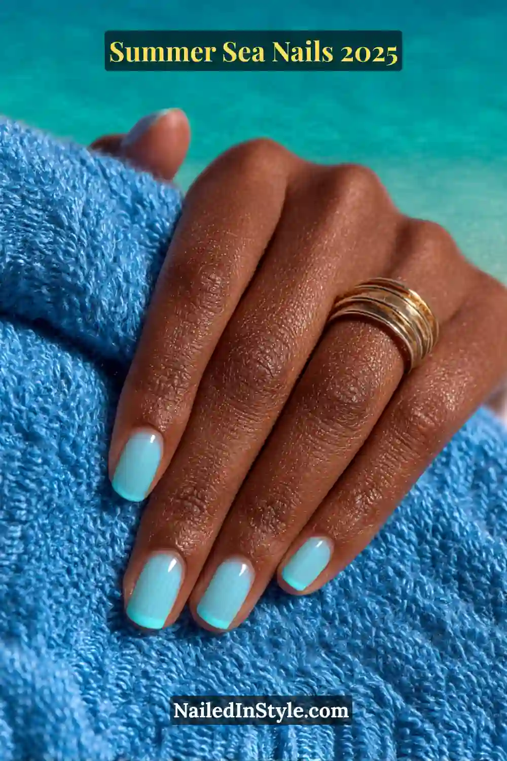 Close-up of short nails with neon turquoise micro-French tips over glossy sky blue base on dark skin