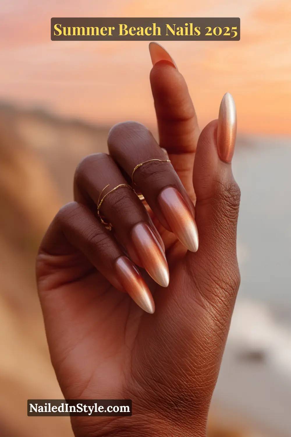 Summer Beach Nails 2026: Tropical, Trendy & Totally You 3 Close-up of a woman's hand with long almond-shaped nails in peach, pink, and rose gold ombré, glowing in sunset beach lighting