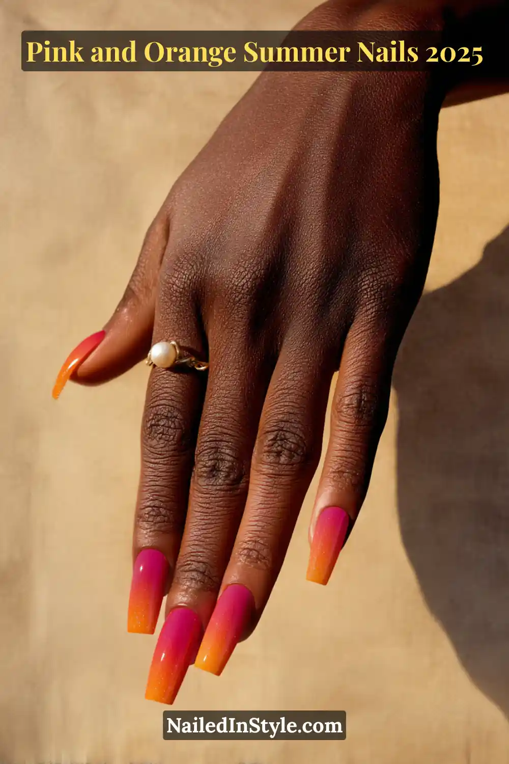 Pink and Orange Summer Nails 2026: Sunset Tips, Endless Vibes 24 Hand with long square-shaped nails featuring a gradient ombré blend from bright pink to neon orange.
