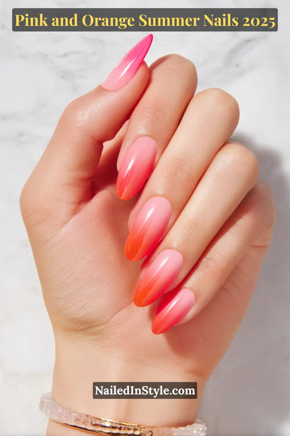 Pink and Orange Summer Nails 2026: Sunset Tips, Endless Vibes 26 A hand with long almond-shaped nails featuring a smooth ombre gradient from soft pink to vivid orange-red.