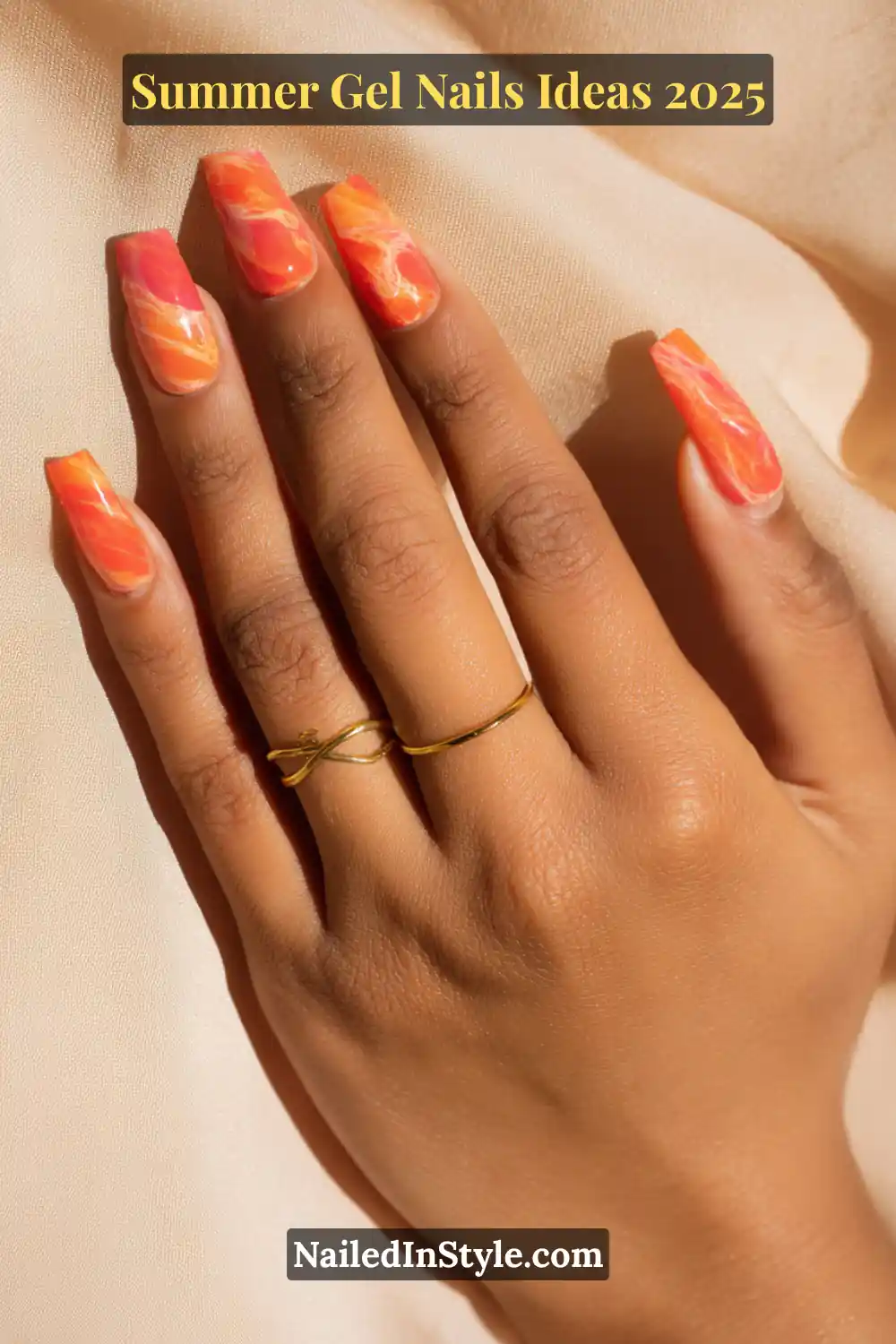 Summer Gel Nails Ideas 2026 23 Close-up of almond-shaped gel nails with coral and orange marble swirl design, summer-inspired.