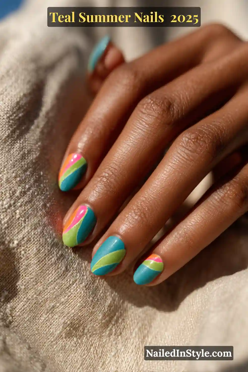 Bold teal summer nails with neon abstract swirl art in hot pink, lime green, and coral orange on a medium-deep toned hand resting on textured linen