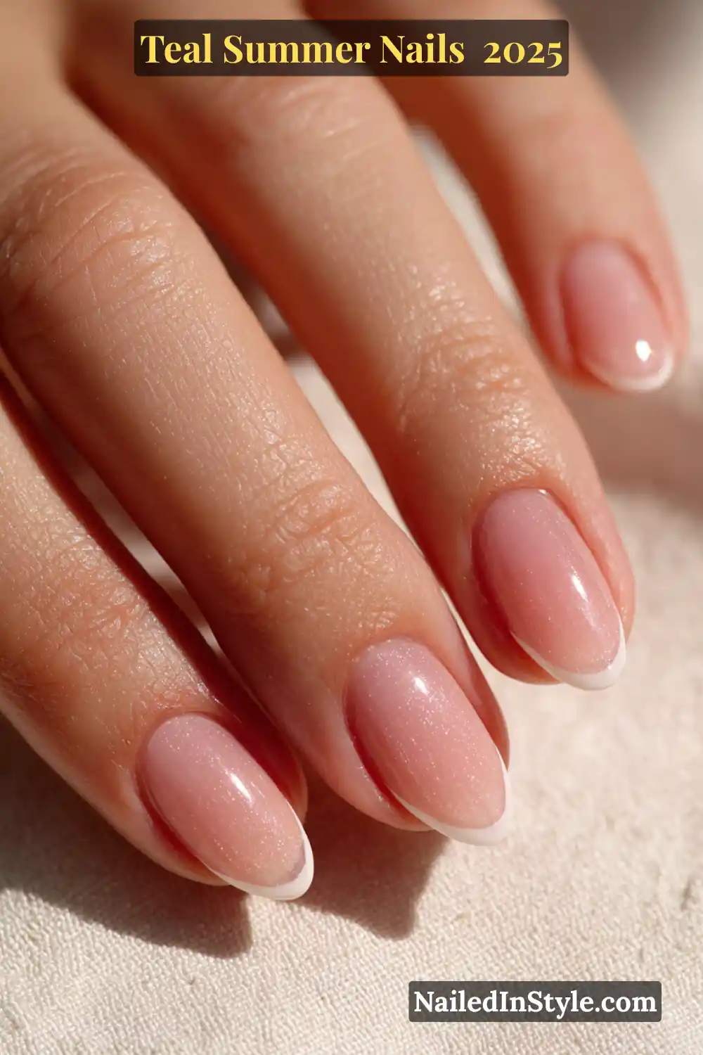 Natural hand with almond-shaped nails featuring a soft glazed pink base and precise white French tips under summer sunlight