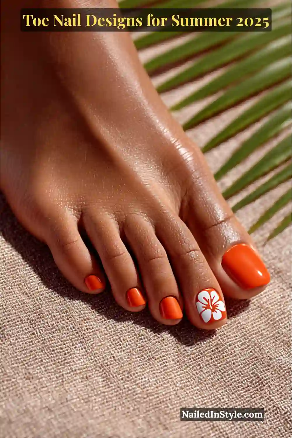 Toe Nail Designs for Summer 2026: Fresh Looks for Every Step 21 Close-up of deep-toned foot with glossy orange polish and a white hibiscus flower design on the toe, set on a tropical linen mat