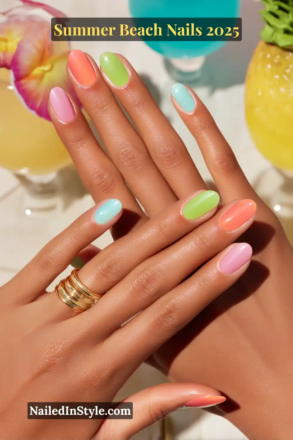Summer Beach Nails 2026: Tropical, Trendy & Totally You 2 Close-up of a woman’s hands with coral, lime green, turquoise, and pink summer beach nails, shot with tropical cocktails in the background