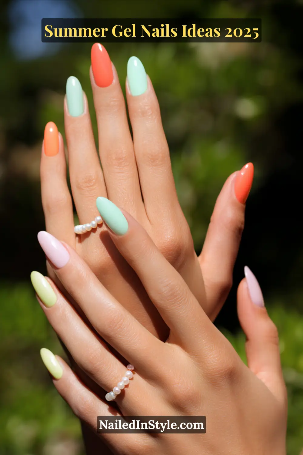 Summer Gel Nails Ideas 2026 7 A vibrant close-up of medium-toned hands with almond-shaped gel nails in a colorful mix of coral peach, mint green, lemon-lime, lavender, and soft sky blue, accessorized with pearl rings.