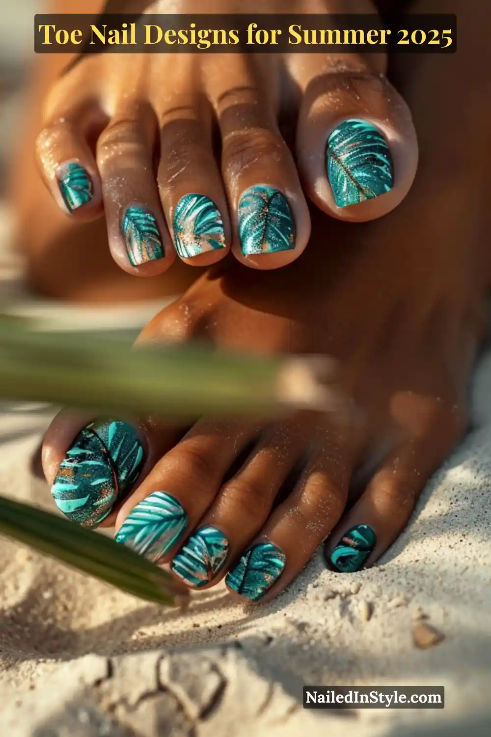 Toe Nail Designs for Summer 2026: Fresh Looks for Every Step 17 Deep-toned toes with turquoise tropical leaf nail art resting on sunlit beach sand